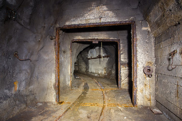 Fototapeta na wymiar Underground mine shaft iron ore tunnel gallery with gate