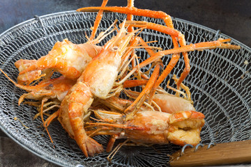 fried shrimp on grate in the restaurant kitchen