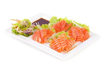 raw salmon with wasabi and sauce isolated on white plate on white background