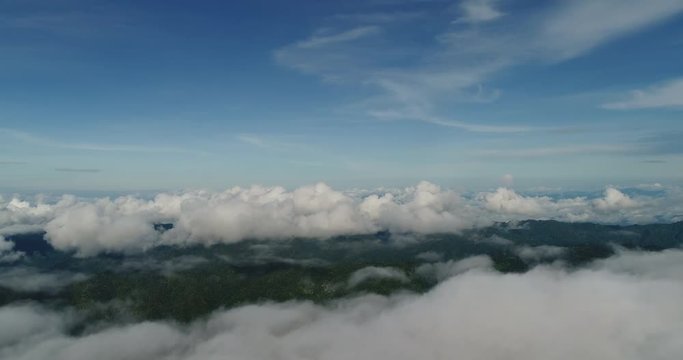 Aerial View. Flying over the beautiful mountain in clouds.