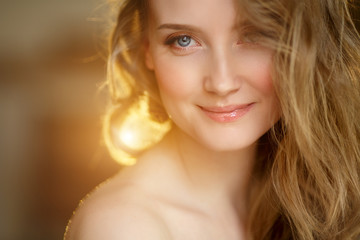 Naklejka premium Romantic blonde. Young beautiful cute woman. Beauty girl with long shiny hair, glowing skin and voluminous haircut
