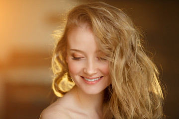 Naklejka premium Romantic blonde. Young beautiful cute woman. Beauty girl with long shiny hair, glowing skin and voluminous haircut