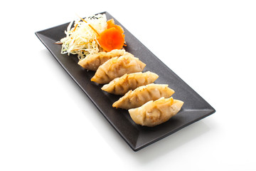 Fried Dumpling isolated on black plate on white background, Gyoza