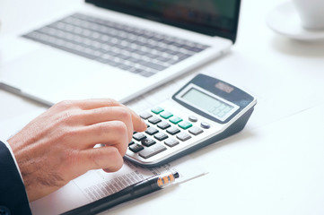 Businessman using calculator