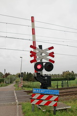Railroad crossway with red light where number of Saint Andrew's crosses marks the number of tracks