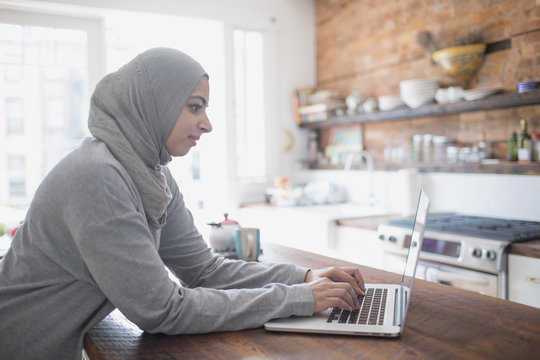 Muslim businesswoman working from home on her laptop