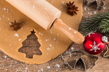 christmas bakery concept background baking cookies pastry rolling pin shaped cutters and red...