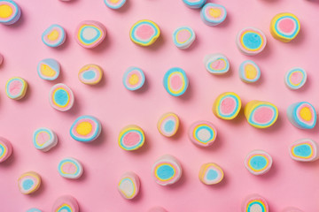 Minimal flat lay. Top view of the pastel marshmallows on a pinkbackground.