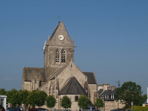 Famous church of Sainte-Mère-Église with dummy paratrooper on it. 