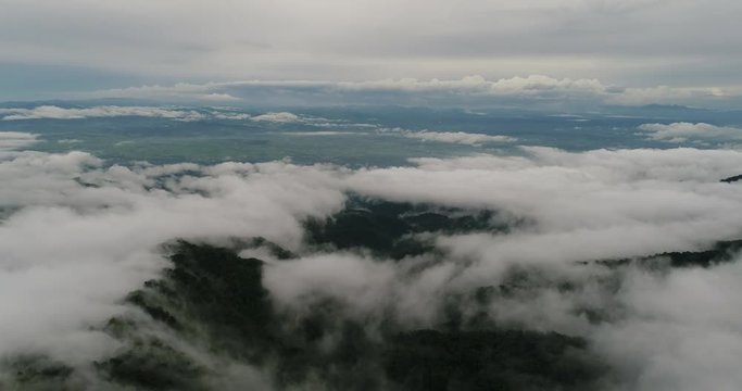Aerial View. Flying over the beautiful mountain in clouds.
