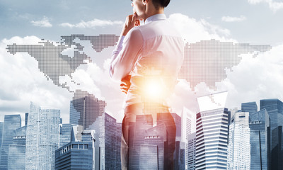 Concept of business success and control with confident boss against cityscape background