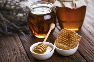 Jar full of fresh honey and honeycombs