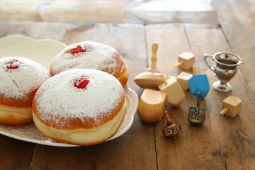 image of jewish holiday Hanukkah background with traditional spinnig top and doughnuts.