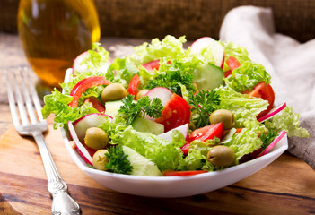  bowl of fresh salad with vegetables and greens