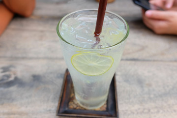 Cold and Fresh Lemon soda juice on wooden table in Restaurant