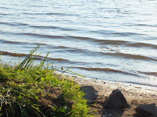 shore of the pond. small waves wash the sandy shore. shore of the island. wild beach.