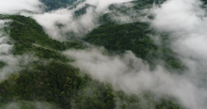 Aerial View. Flying over the beautiful mountain in clouds.