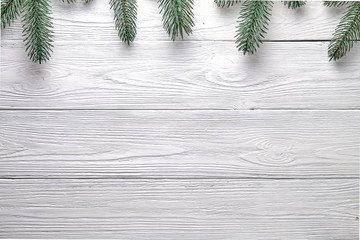 Christmas background. Branches of a Christmas tree on a wooden background with copy space.