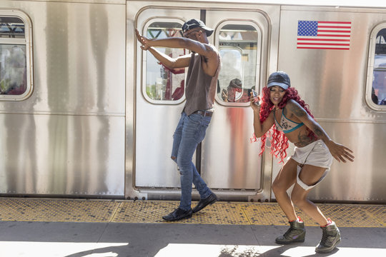 Couple dancing beside a train