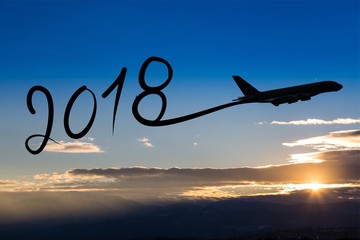 New year 2018 drawing by airplane on the air at sunrise