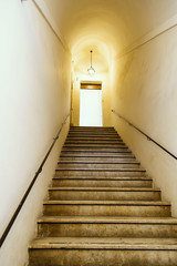 Fototapeta na wymiar Old staircase with metal wall mounted handrail