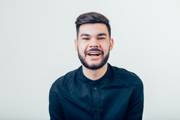 Obraz premium Handsome young man looking at camera. Portrait of laughing young man