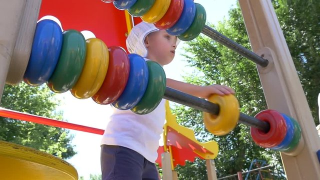 Little boy with a great pleasure finds the rings on the playground