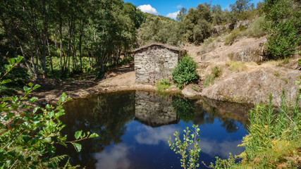 Fototapeta na wymiar Abandoned watermill and pond
