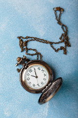 Pocket watch on blue background