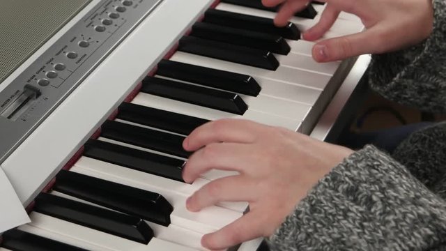 girl at home rehearsing on electronic piano