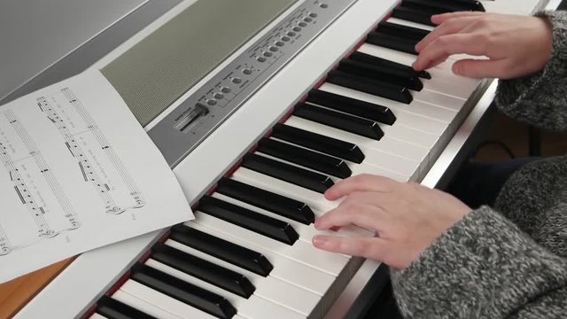 girl at home rehearsing on electronic piano