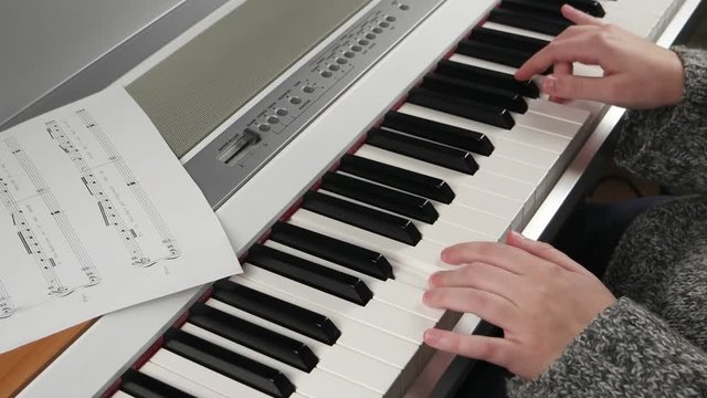 girl at home rehearsing on electronic piano