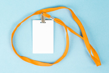 Empty ID card / icon with an orange belt, on a blue background. Space for text