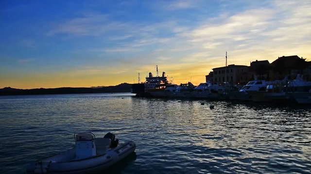 Boats in La Maddalena shore at sunset. Sardinia, Italy
