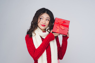 Asian woman in red warm clothes with gift. Holidays New Year and Christmas.