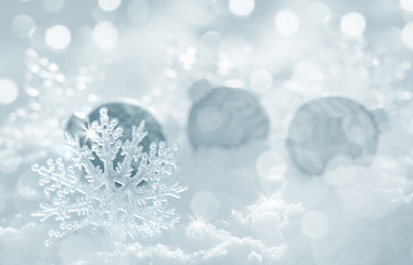 Christmas background with decorative snowflake and balls in the snow