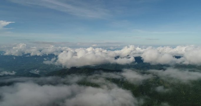 Aerial View. Flying over the beautiful mountain in clouds.