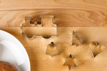Christmas cookie cutter in different shapes, top view, on wooden board