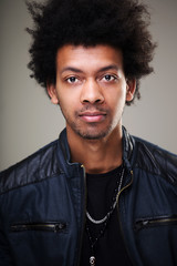 Fototapeta premium man with bushy curly hair blinking his eye having warm broad smile