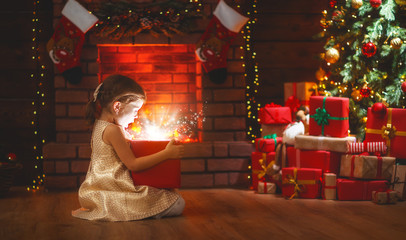 Fototapeta na wymiar child girl with magic gift on Christmas Eve
