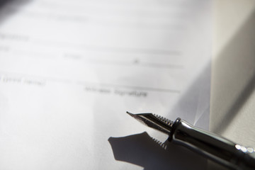 Close-up of Contract form with open fountain pen