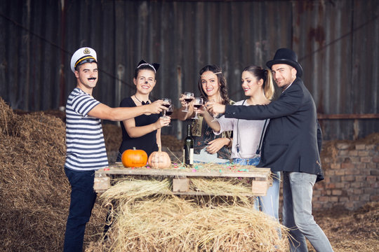 Group of adults drinking and having fun on halloween party
