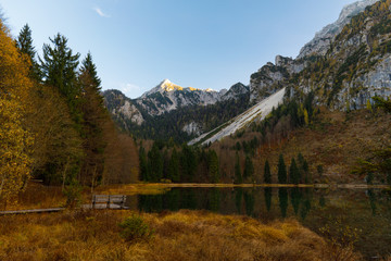 Reflection on Lake Frillensee, Inzell, Bavaria, Germany at sunset in fall with Mount Hochstaufen in Background
