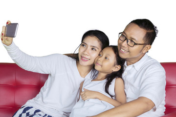 Young family taking a picture together on studio