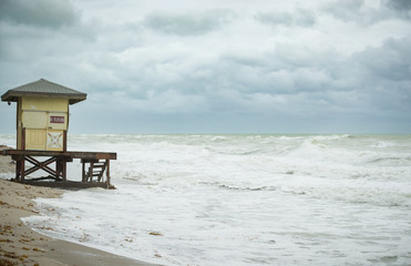 Beach view with waves. Morning on the ocean or sea beach. Lifeguard house.