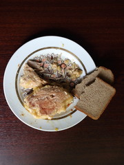 a plate of stewed meat on the table and bread