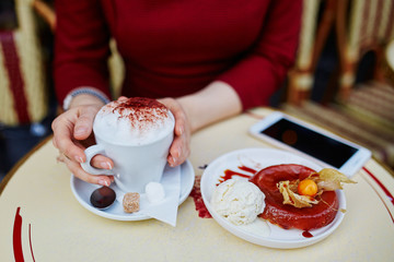 hands with mobile phone, cup of coffee and cakE