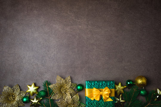 Christmas background with gift box and decorations on dark background. Top view