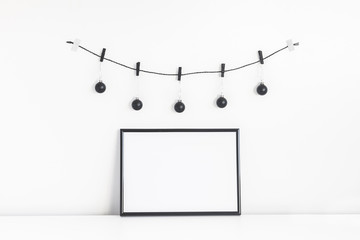 Christmas composition. Black frame and christmas decorations on white background. Front view, mock...