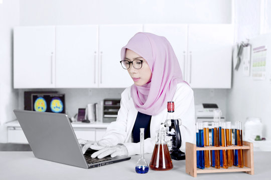 Female researcher working with laptop